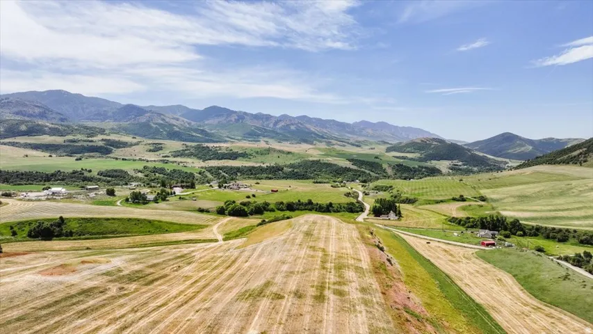 Expansive rural landscape featuring rolling hills and distant mountains