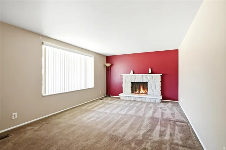 Living room featuring a stone-clad fireplace and hearth
