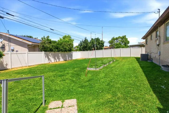 Expansive green lawn with perimeter fencing