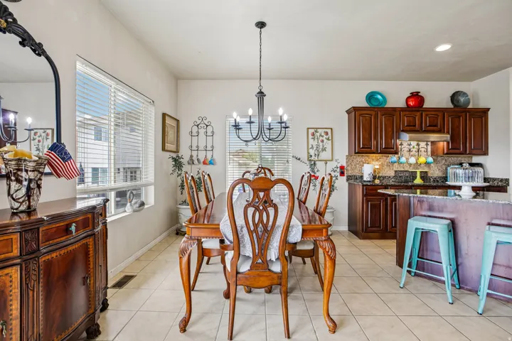 Dining area with tile flooring and a dark wood dining table