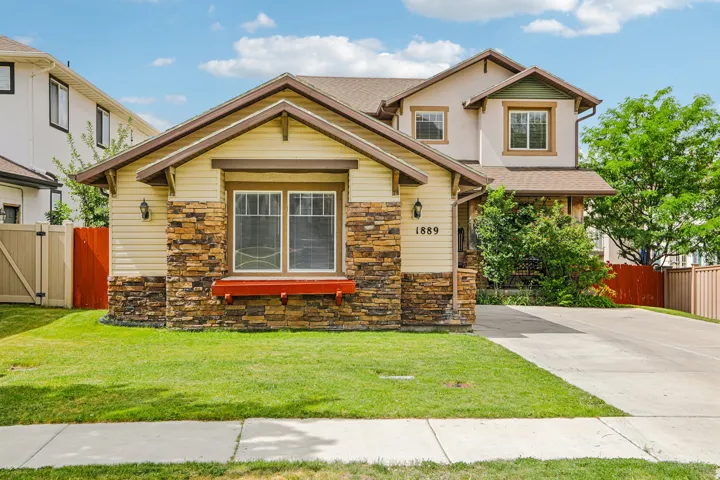 Multi-level facade featuring stone accents, siding, and stucco finishes