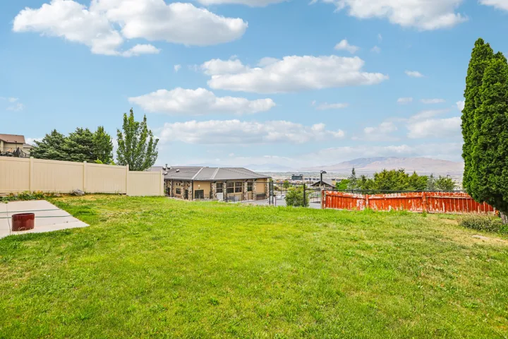 Expansive green lawn with mountain backdrop