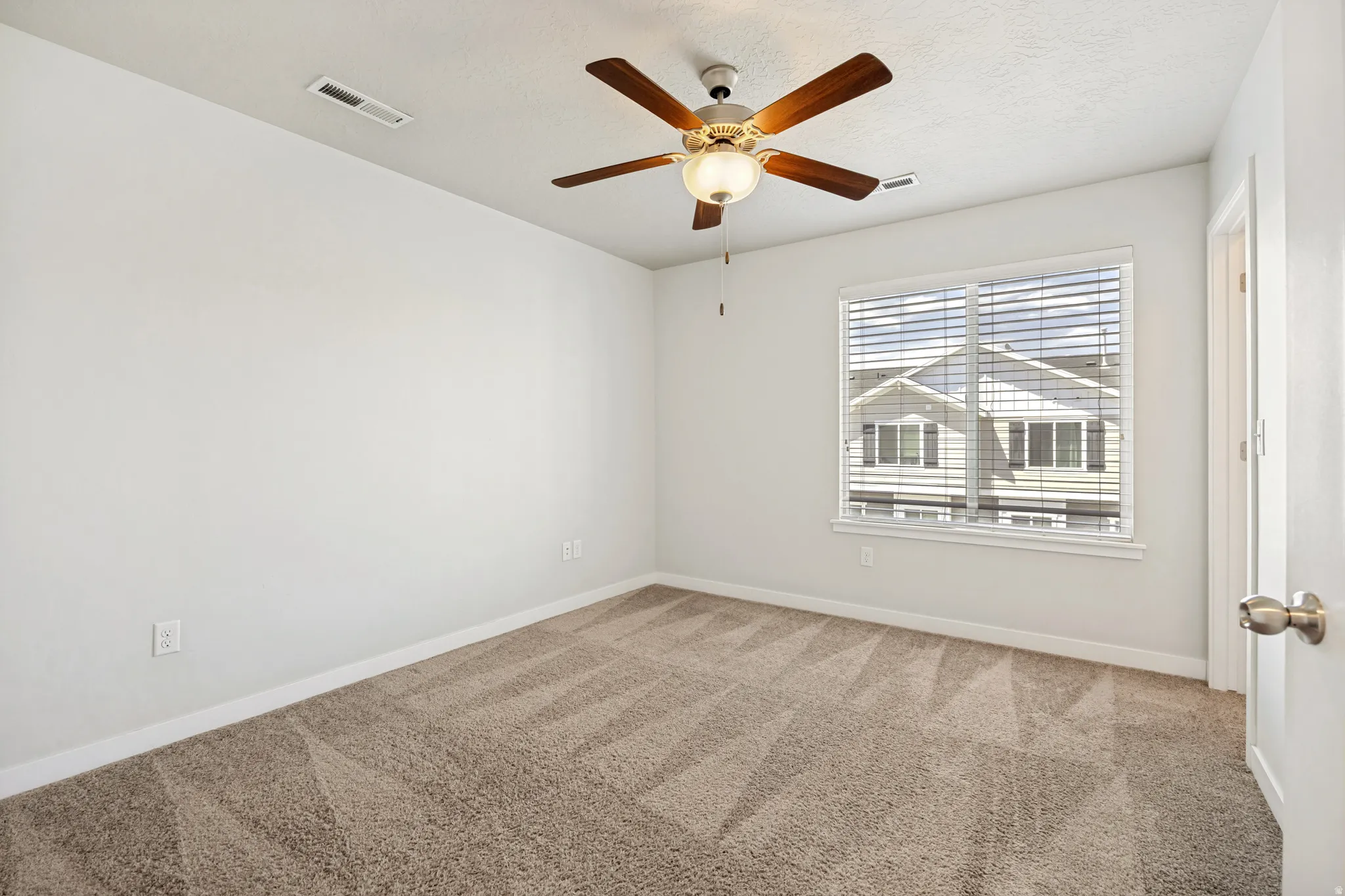 A bright primary bedroom where natural light pours in throughout the day.