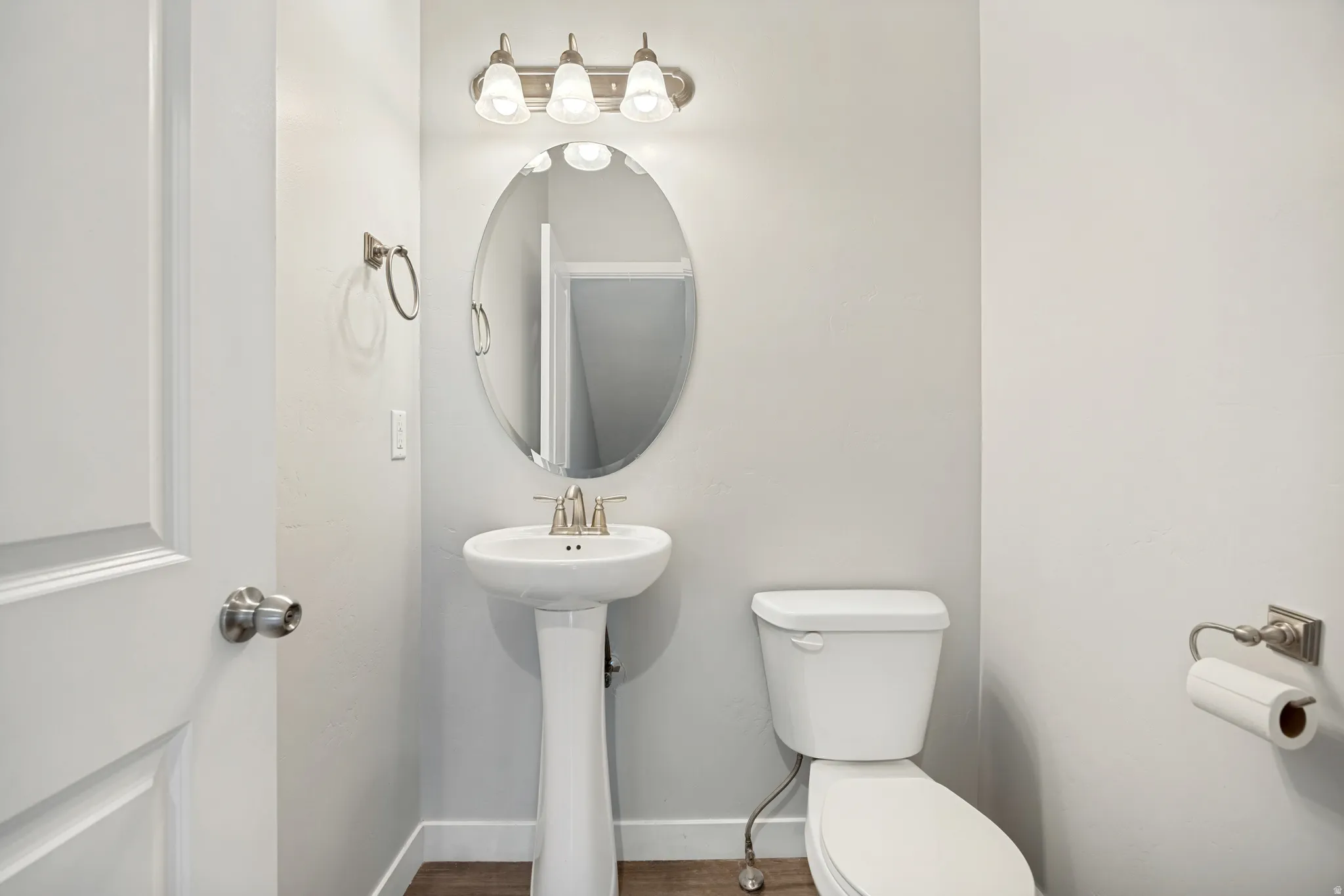 A well-situated half bath welcomes you as you reach the top of the stairs.