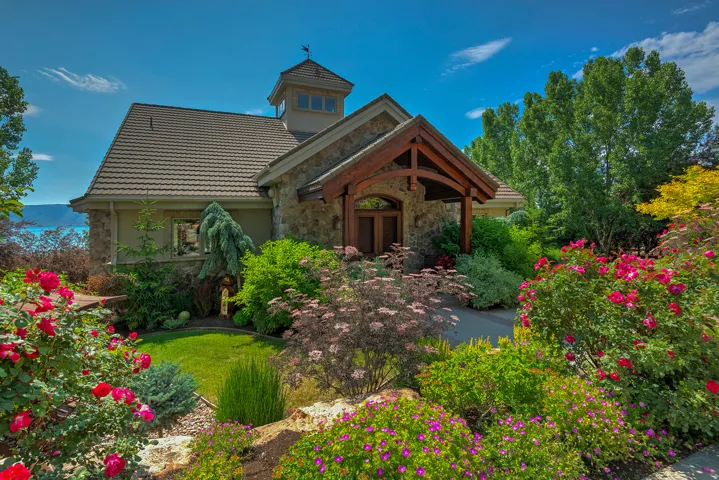 Stone exterior with a prominent wooden entryway featuring arched beams