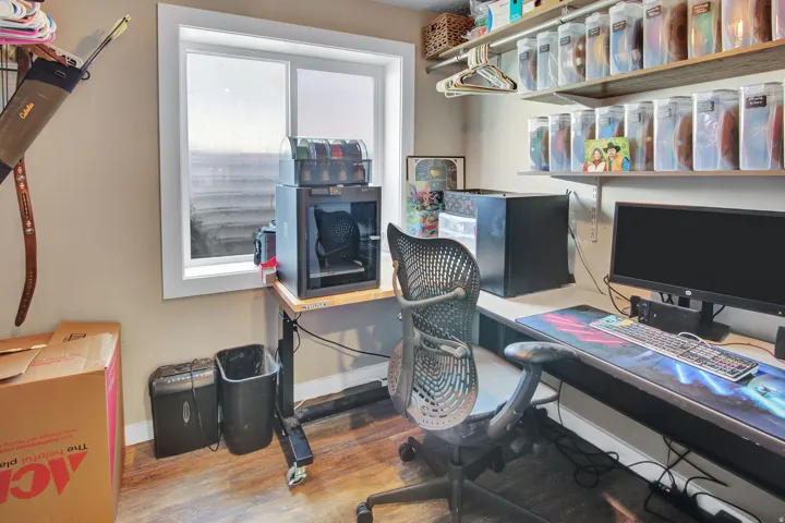 Dedicated office space with a window, wood-finish flooring, and neutral wall tones