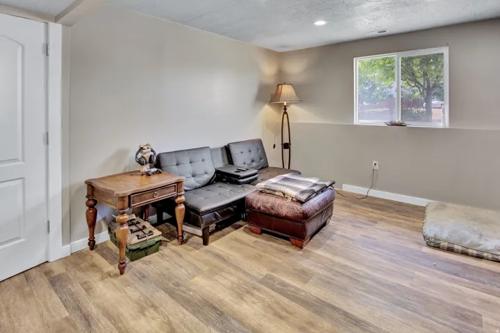 Finished room featuring wood-finish flooring, recessed lighting, and a white-framed window