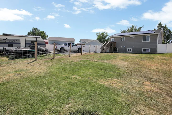 Expansive lawn area with a partial privacy fence