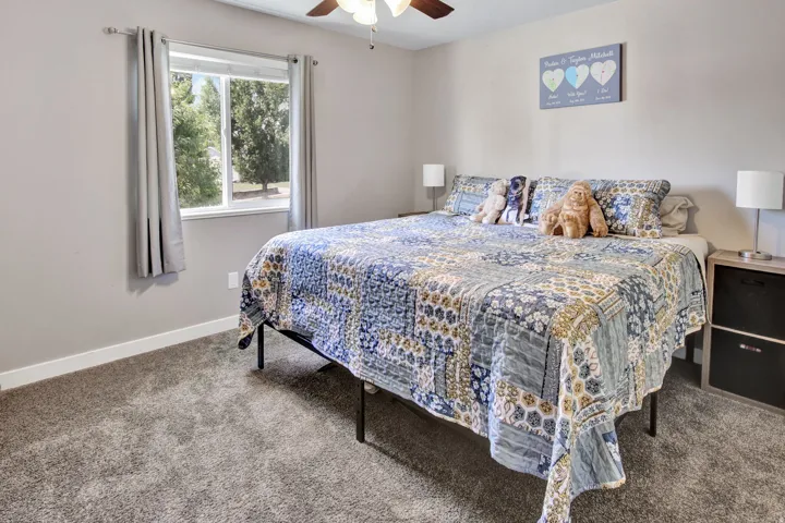 Neutral-toned walls complement the gray carpeting