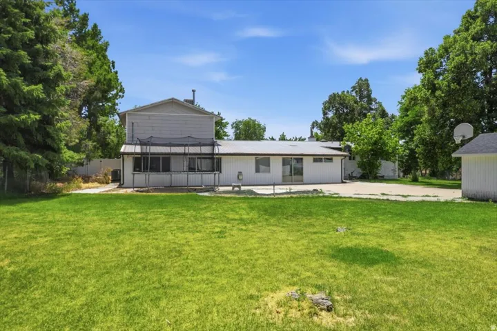 Expansive green lawn with mature perimeter trees