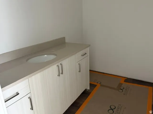 Light wood-finish vanity featuring brushed nickel hardware