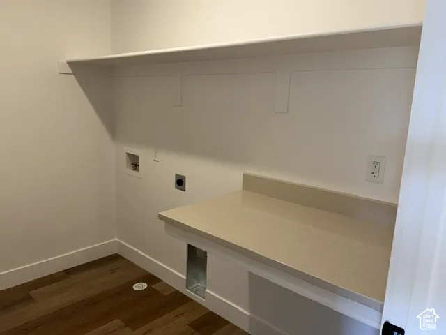 Built-in shelf, counter space, wood-finish flooring, and wall outlets