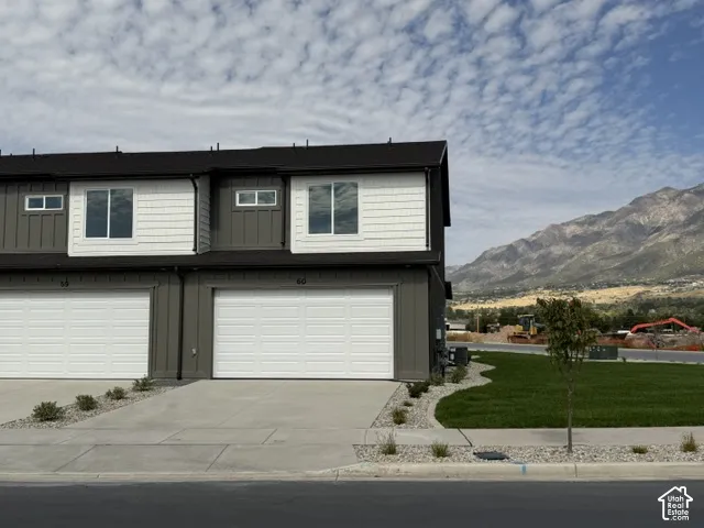 Modern exterior with dark siding and white shingle accents