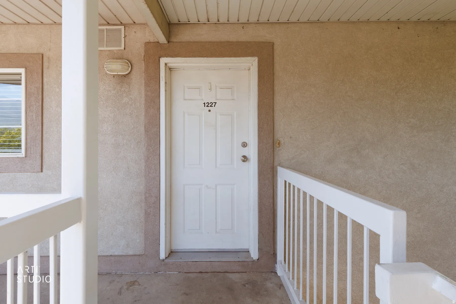 Entry door with visible address numbering, featuring a paneled design and polished hardware