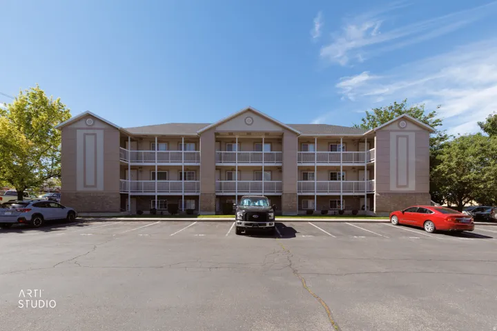 Three-story building with a neutral-toned facade and gabled roofline