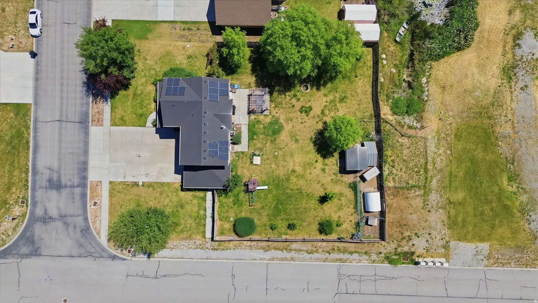 Single-story residence featuring a dark shingle roof with solar panels