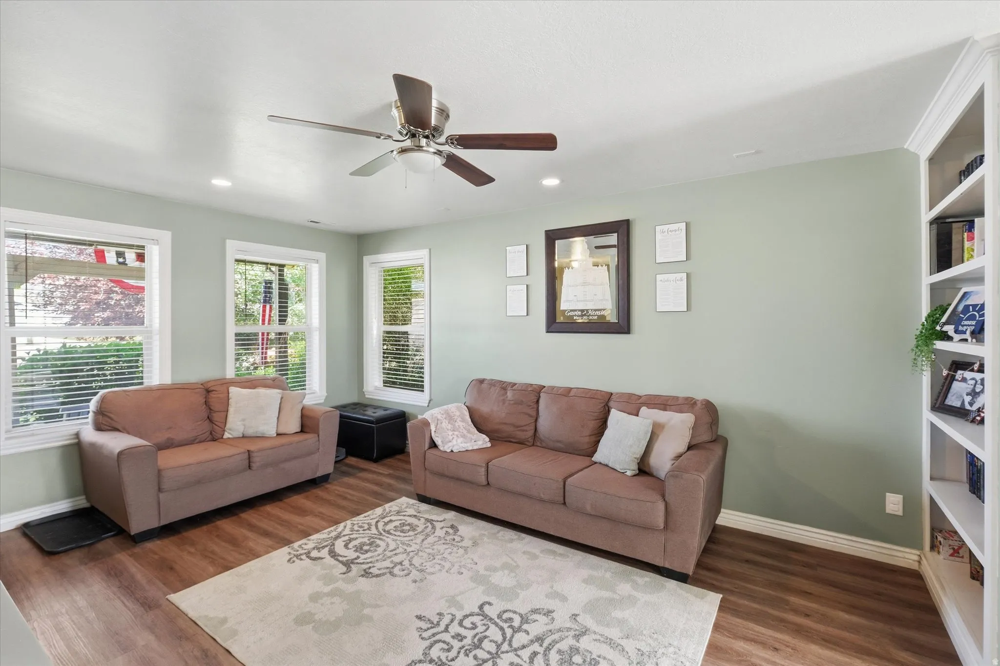 Spacious living area featuring wood-finish flooring, recessed lighting, and a ceiling fan