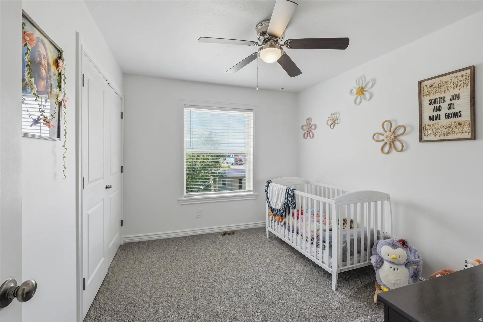 Room featuring light gray carpeting, neutral wall paint, and a window with horizontal blinds