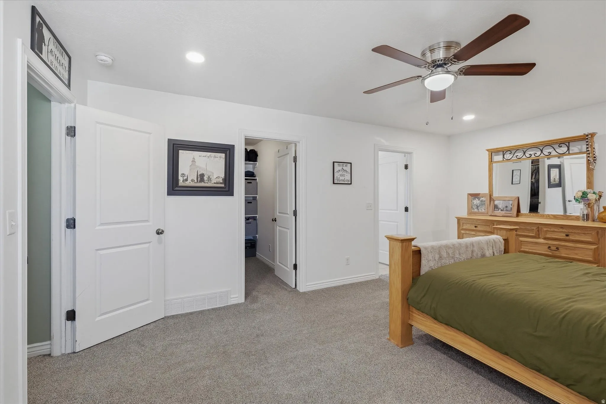 Spacious interior featuring neutral carpet flooring, recessed lighting, and a ceiling fan with light fixture