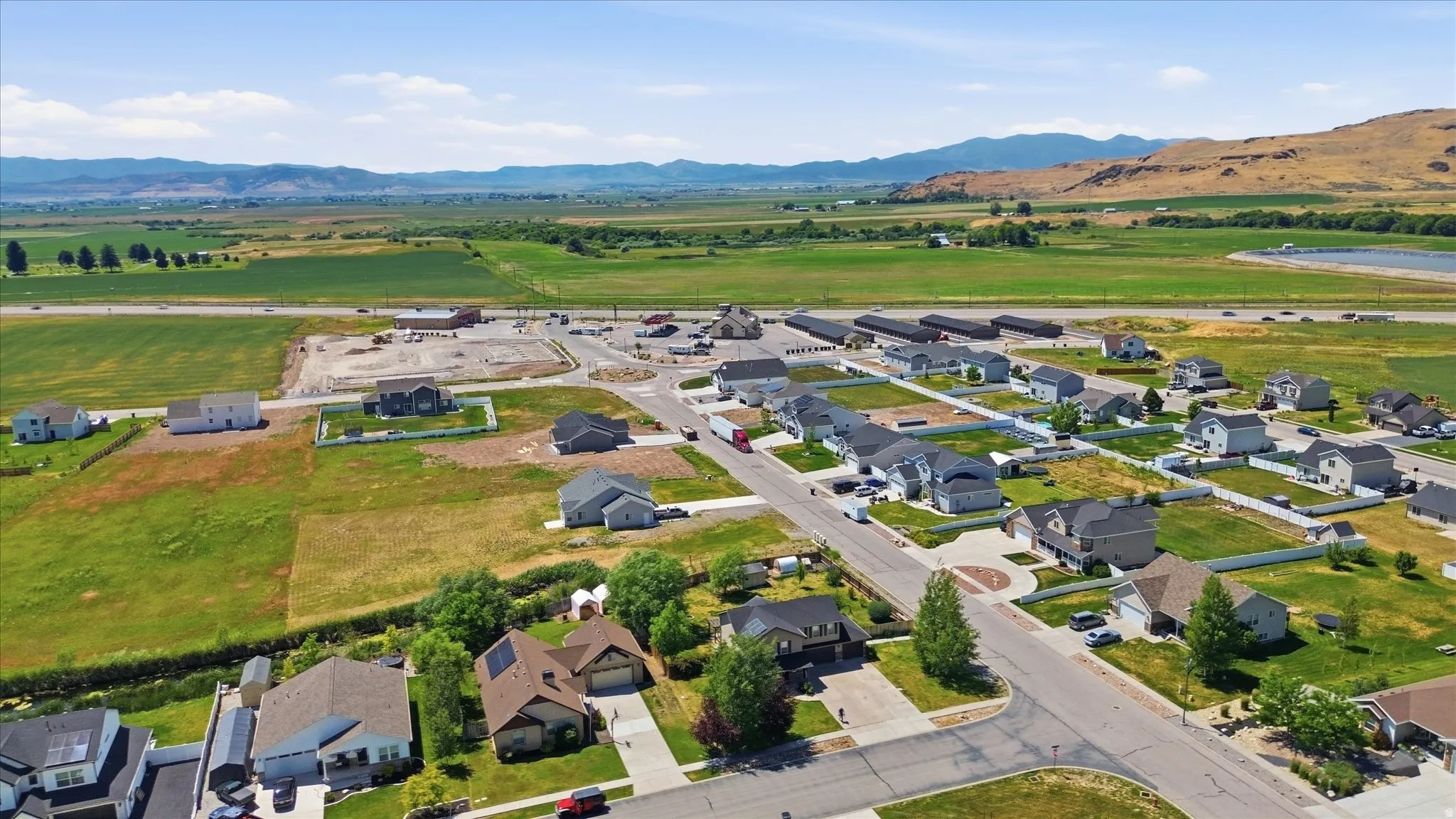 Aerial perspective showcasing a residential development with established homes and new construction sites
