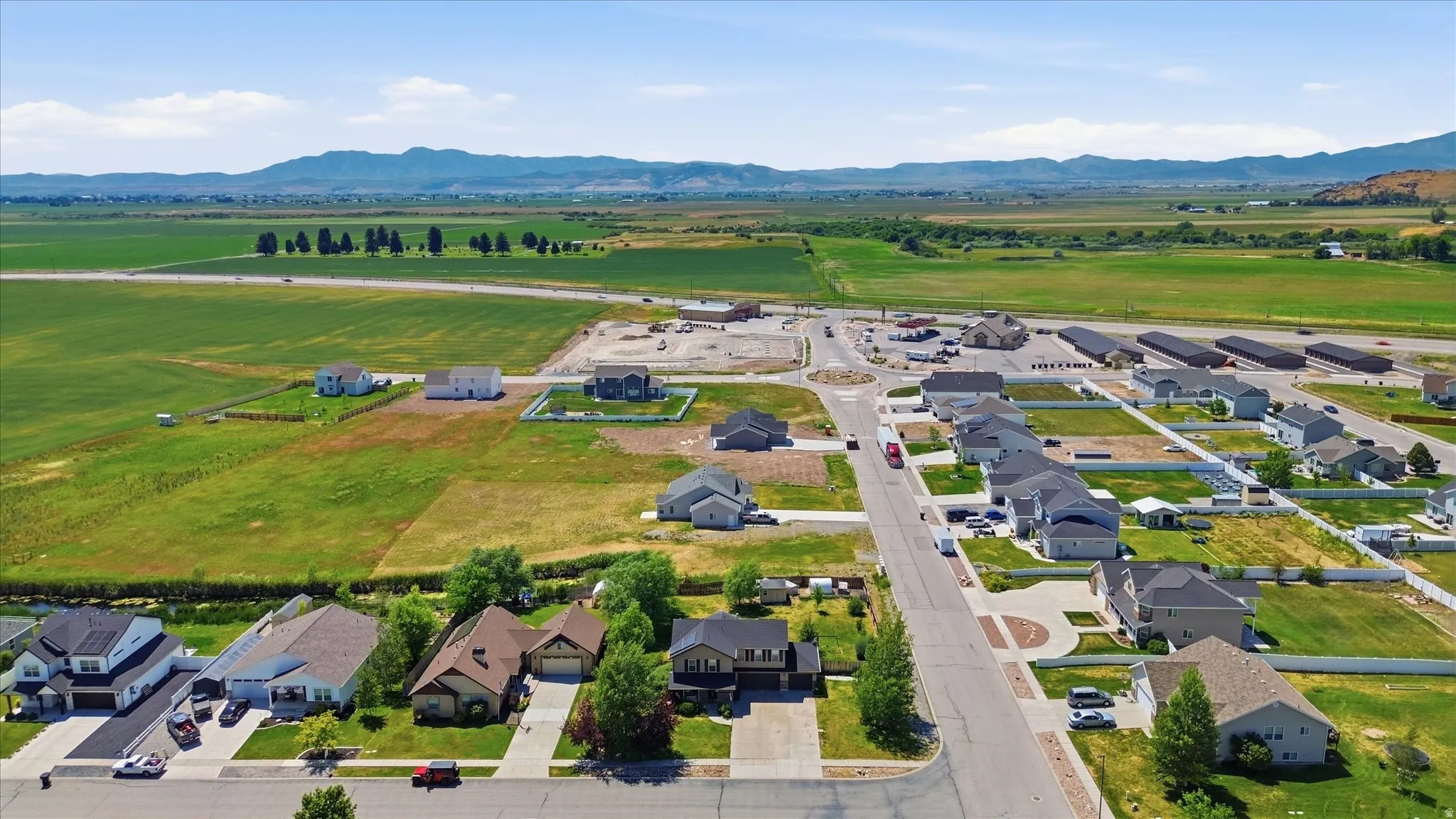 Aerial perspective showcasing a developing residential area with single-family homes and undeveloped lots