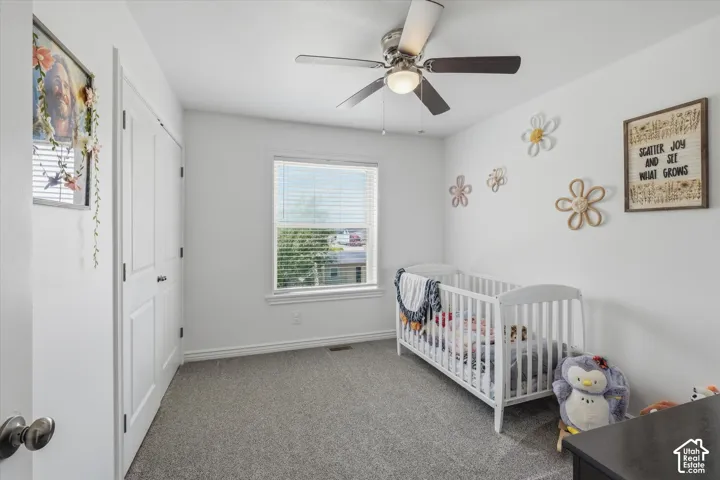 Room featuring light gray carpeting, neutral wall paint, and a window with horizontal blinds