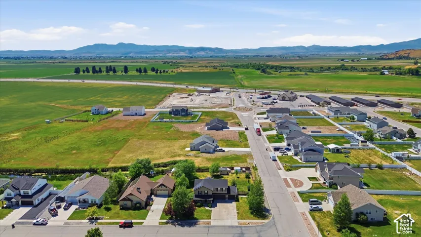 Aerial perspective showcasing a developing residential area with single-family homes and undeveloped lots