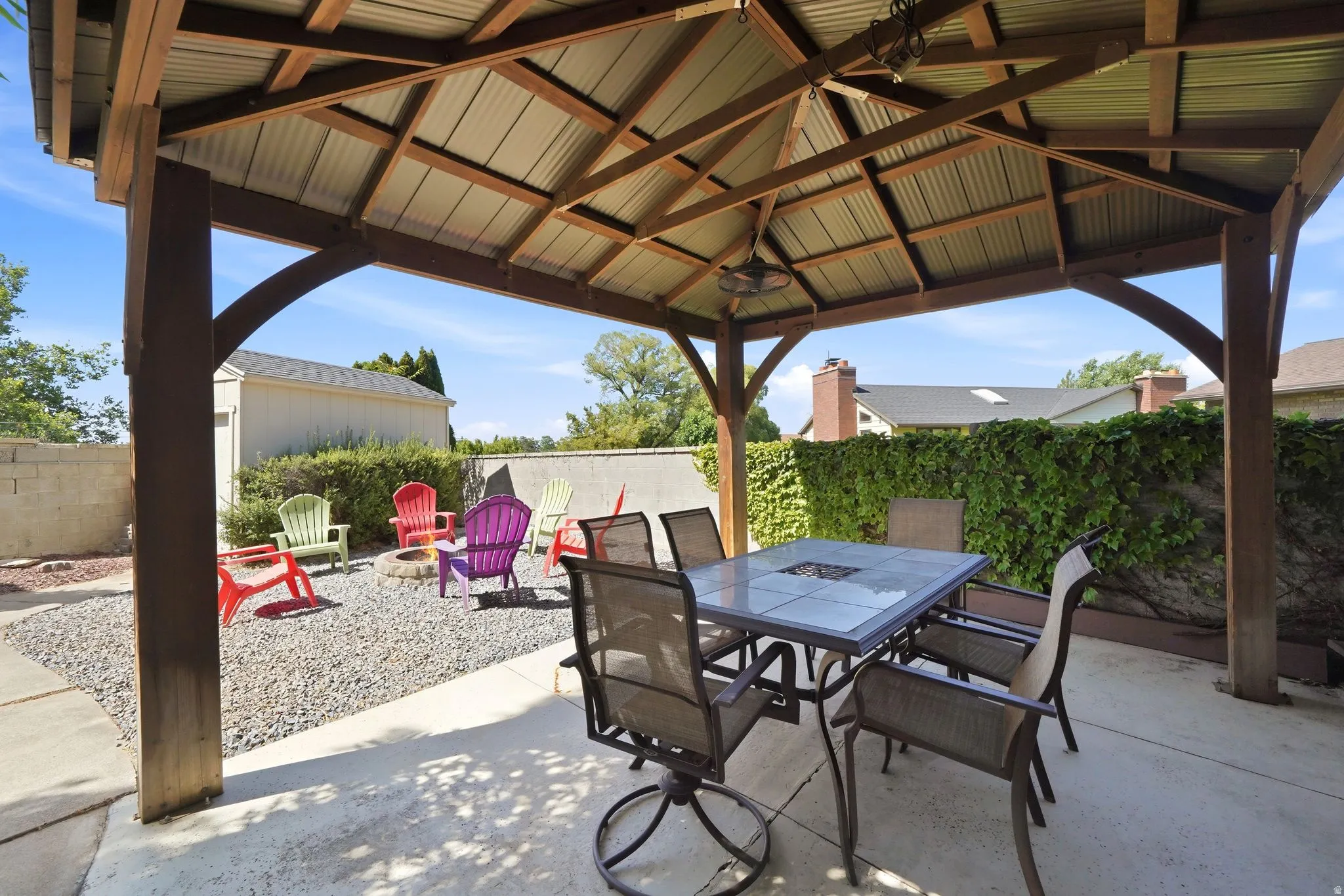 Covered patio with a wood-frame gazebo and corrugated metal roof