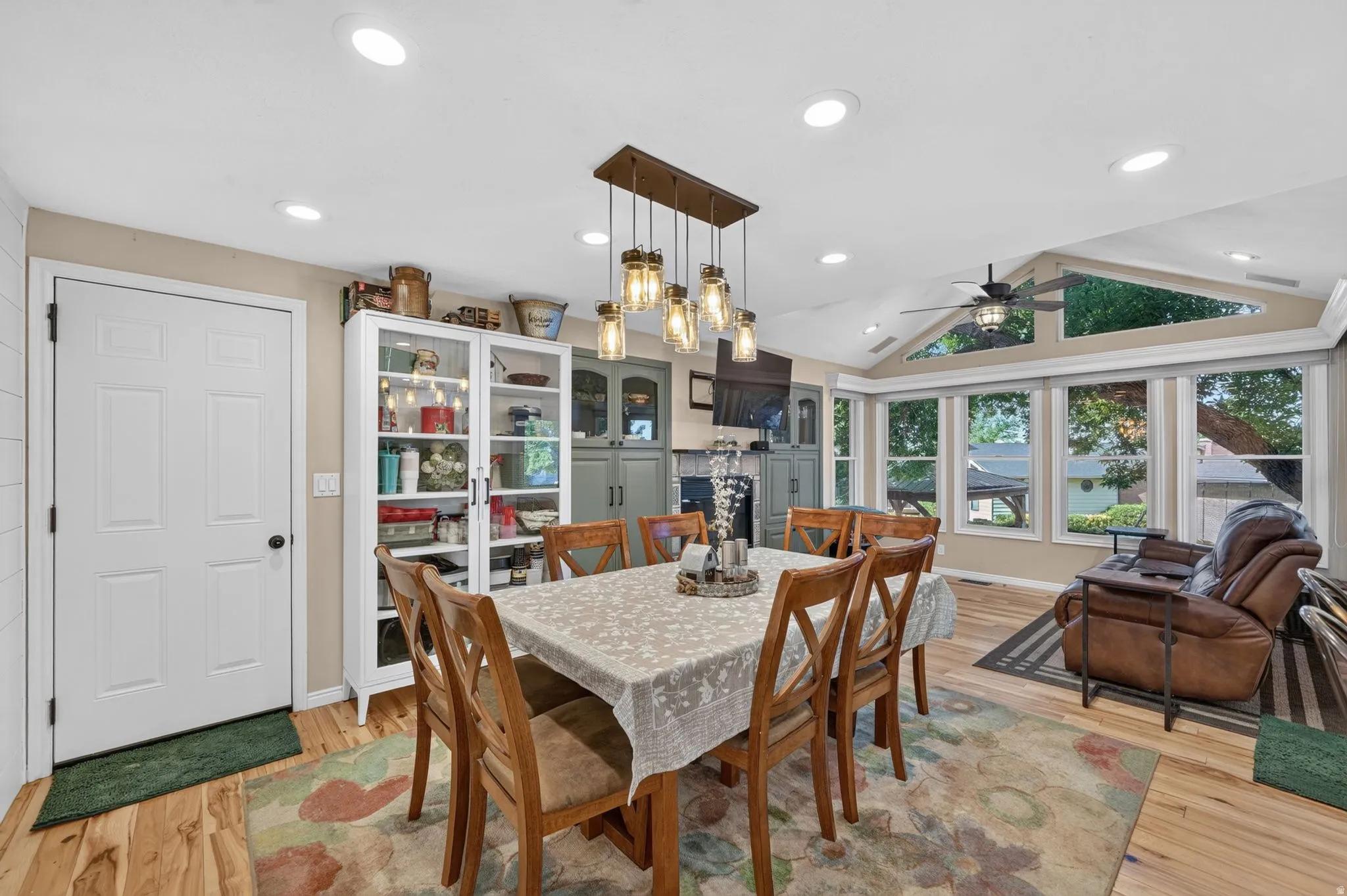 Dining area featuring wood-finish flooring and a rectangular chandelier with Edison-style bulbs