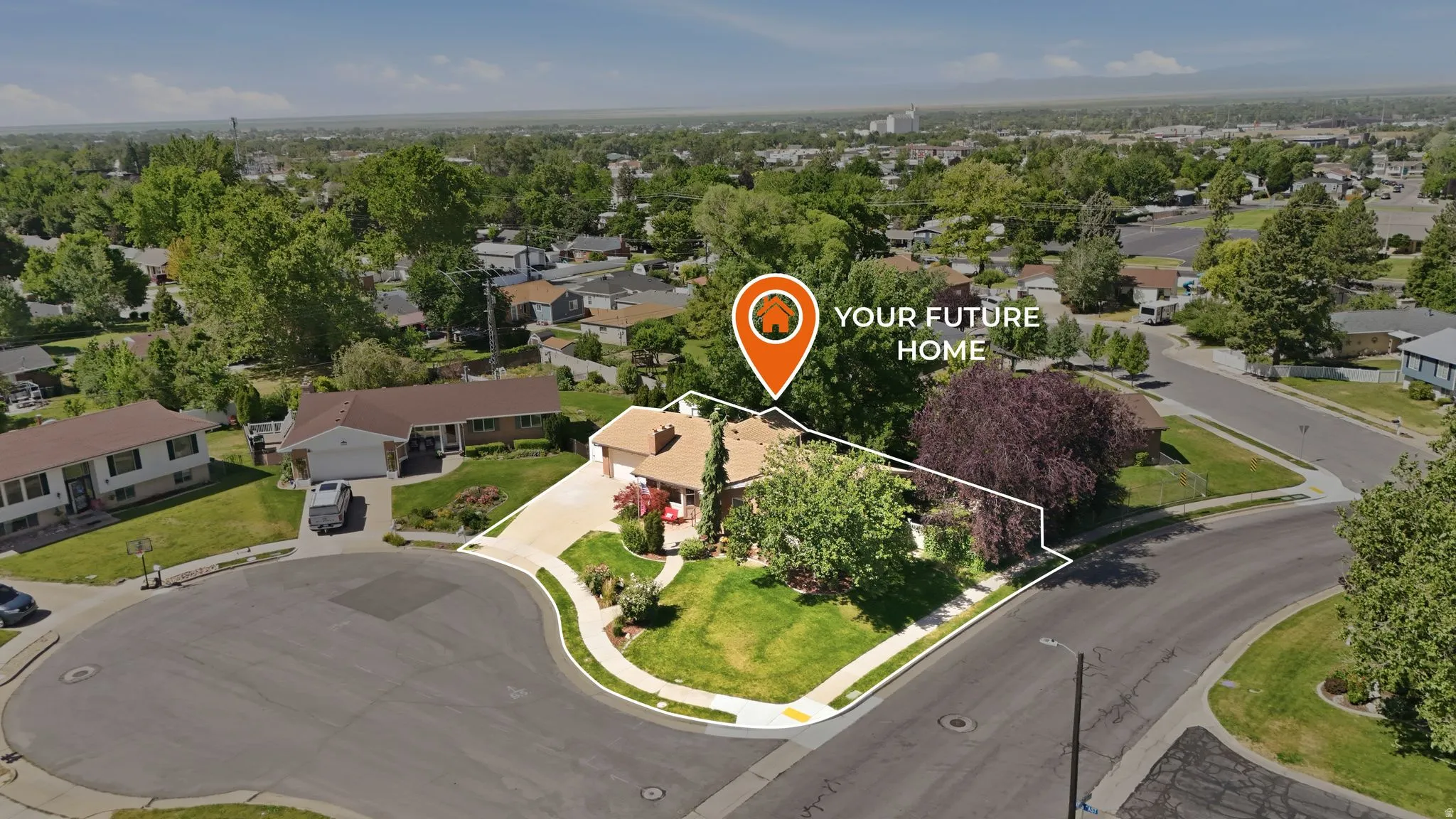 Aerial perspective showcasing a residence with an attached garage, positioned on a corner lot with a cul-de-sac
