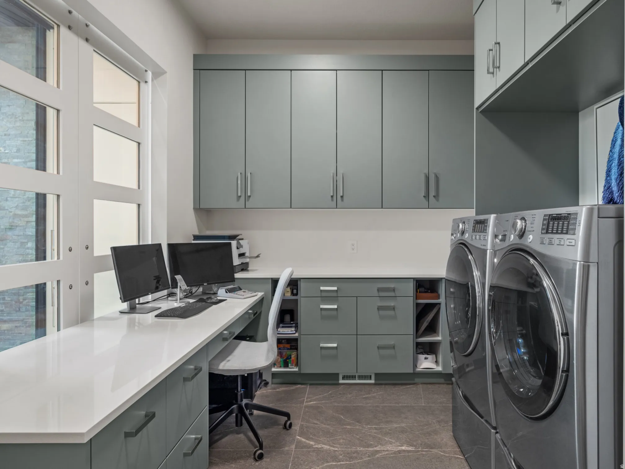 Integrated workspace and storage cabinets with quartz countertops.  The multi-pane doors slide open when you don't need the privacy.