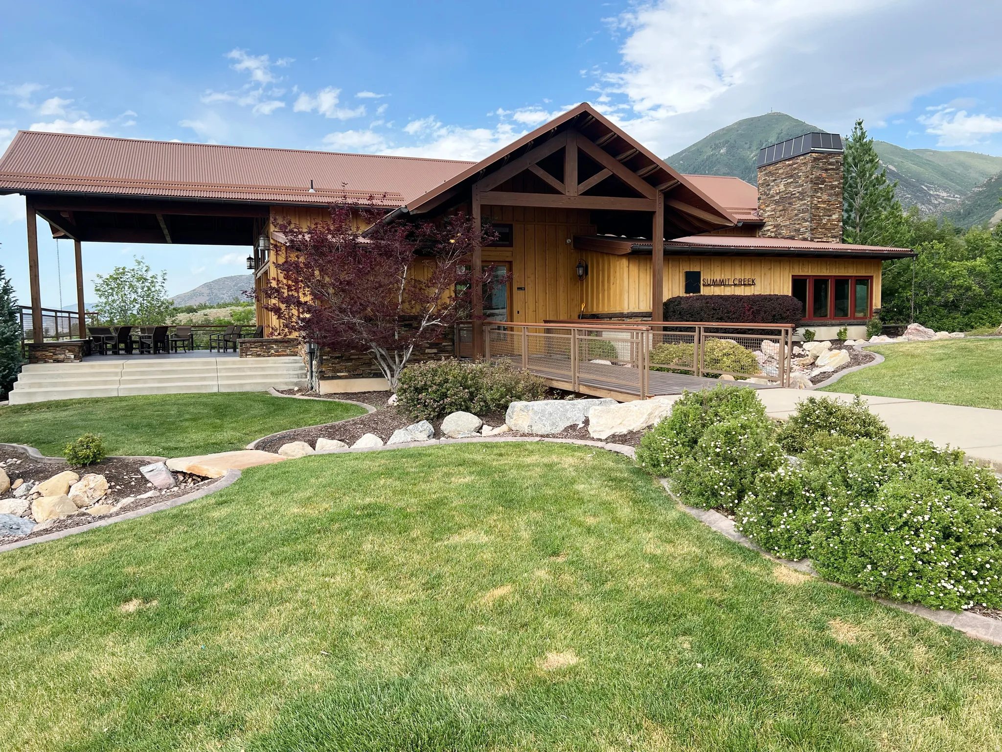 Mountain-style architecture featuring natural wood siding and stone accents