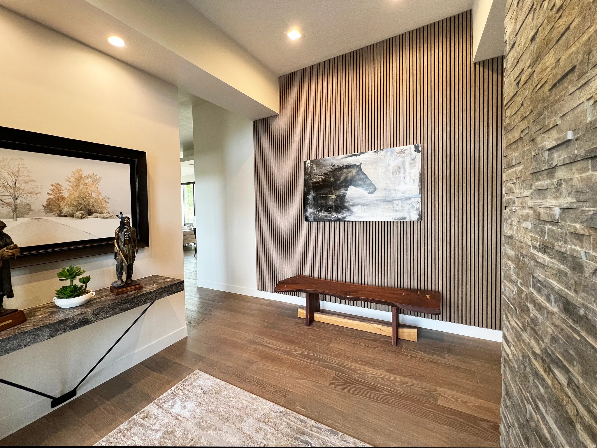 Entryway featuring wood-slat accent wall and stacked rock wall.