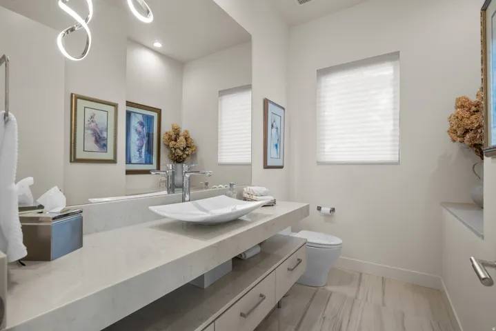 Powder room with floating vanity and a vessel sink