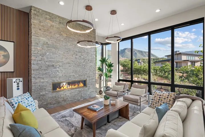 Great Room with a floor-to-ceiling stone-clad fireplace with a linear fireplace.  Beautiful mountain views.