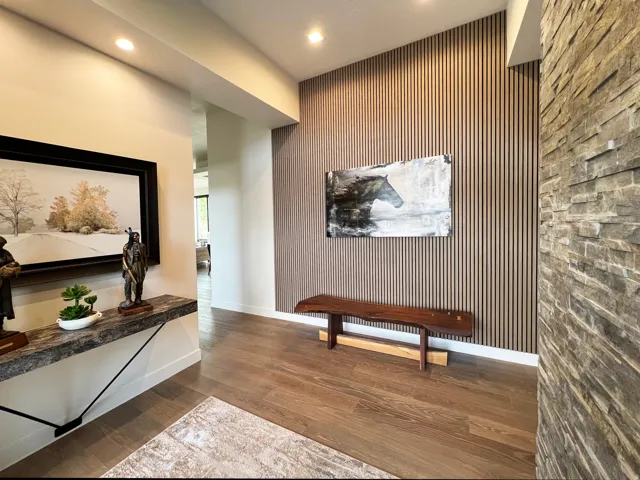 Entryway featuring wood-slat accent wall and stacked rock wall.