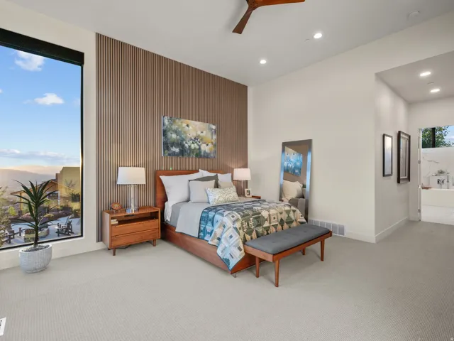 Primary Bedroom with floor-to-ceiling window, slat wood accent wall, recessed lighting, and a ceiling fan