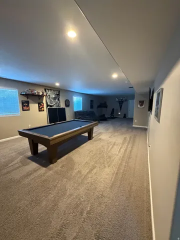 Expansive recreational room featuring recessed lighting and wall-to-wall carpeting