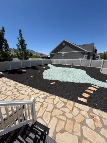 Backyard featuring a flagstone patio and deck access