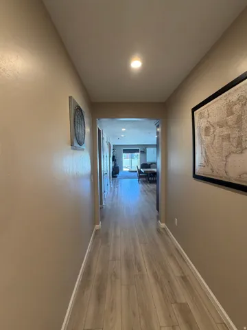 Hallway featuring wood-finish flooring, recessed lighting, and neutral wall tones