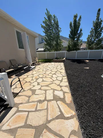 Expansive rear patio featuring flagstone paving