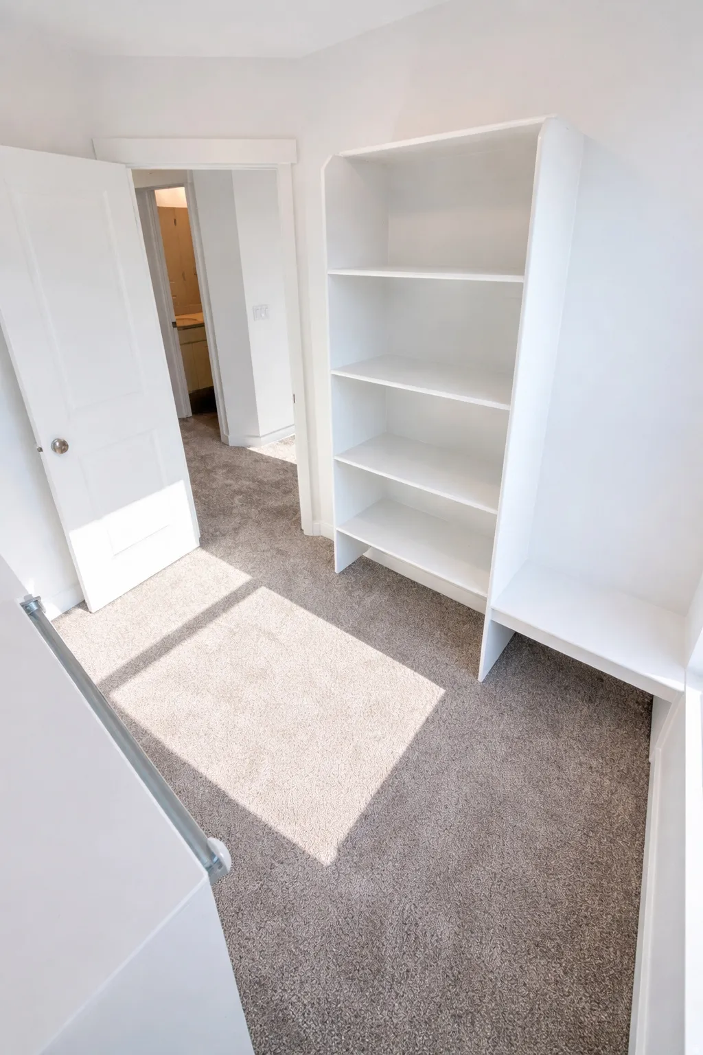 Built-in shelving and storage bench with plush carpeting