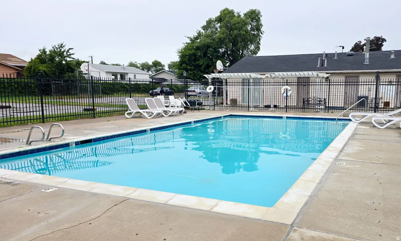 Outdoor swimming pool with integrated steps and perimeter concrete decking