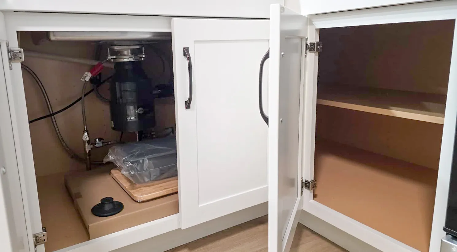White shaker-style cabinetry featuring dark hardware