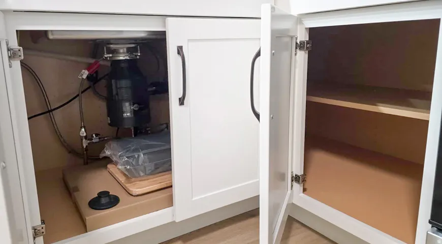 White shaker-style cabinetry featuring dark hardware