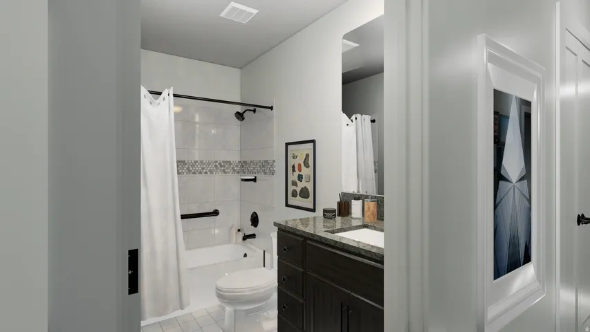 Bathroom featuring a easy-to clean one-piece tub and quartz topped vanity with undermount sink