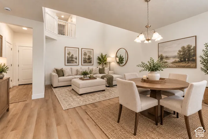 Vaulted ceilings, wood-finish flooring, and a decorative chandelier