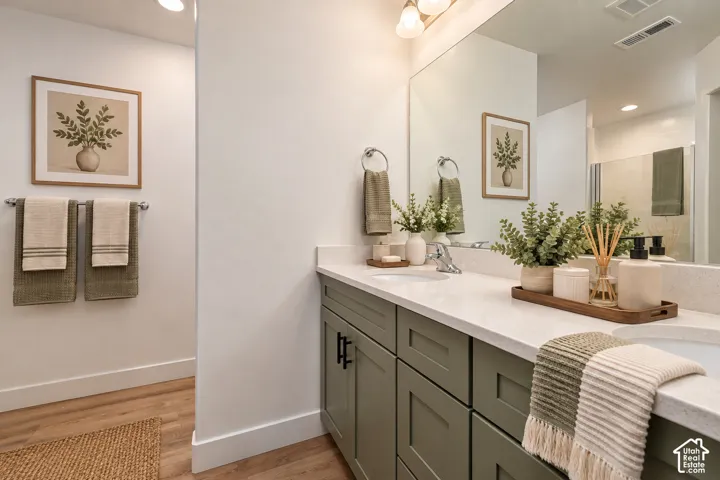 Dual vanity with light-colored countertops, undermount sinks, and matte black hardware