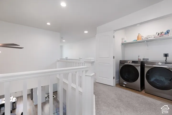 Upper-level laundry area featuring carpet flooring and built-in shelving