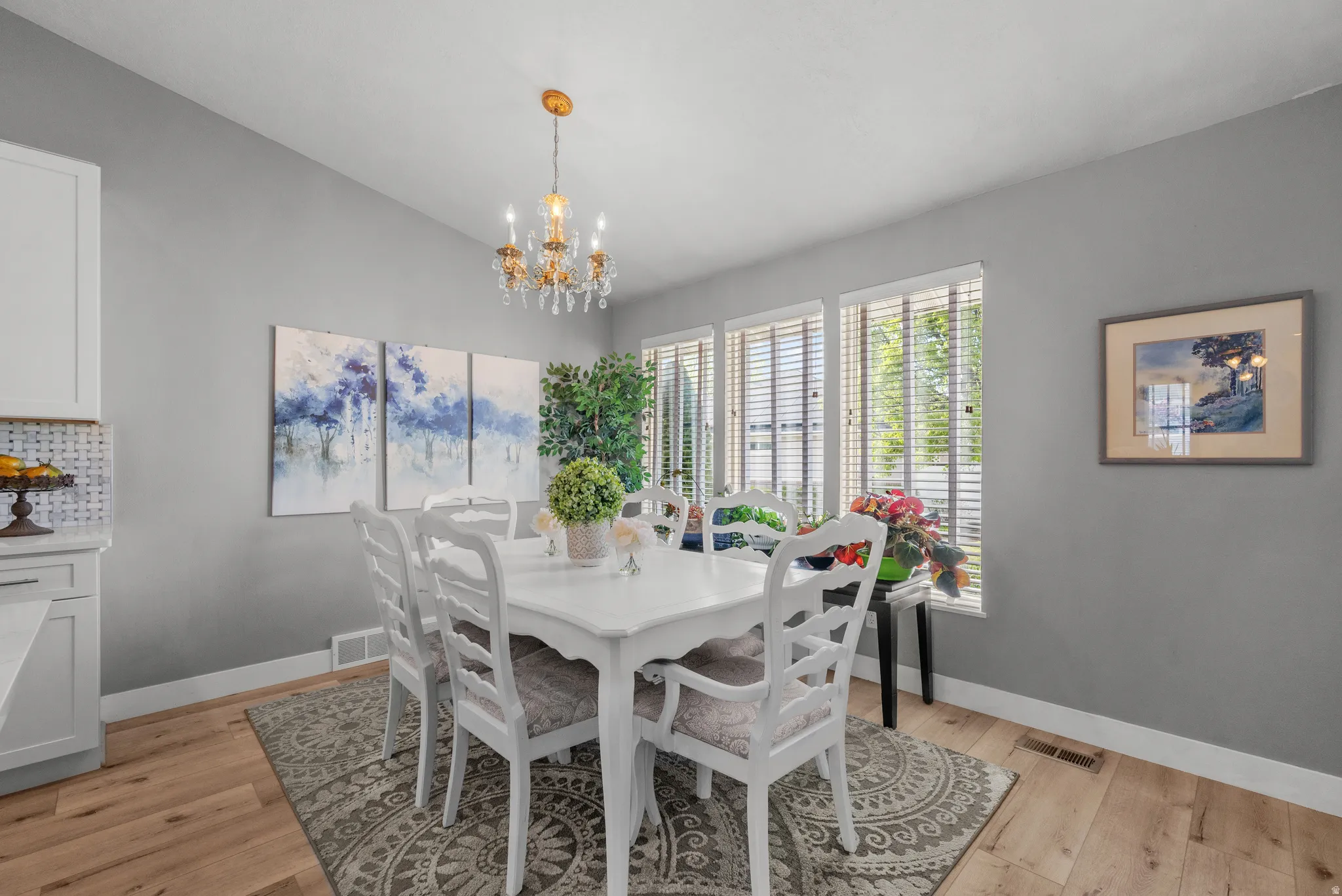 Dining area featuring a chandelier, LVP flooring, and lots of natural light